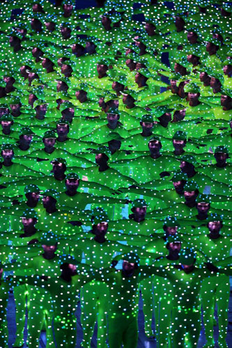Procession of colours and dancers in electronic lighting costumes, symbolizing modern-day China